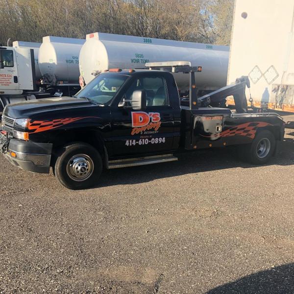 D's Towing black Chevrolet wrecker with orange graphics ready for a call
